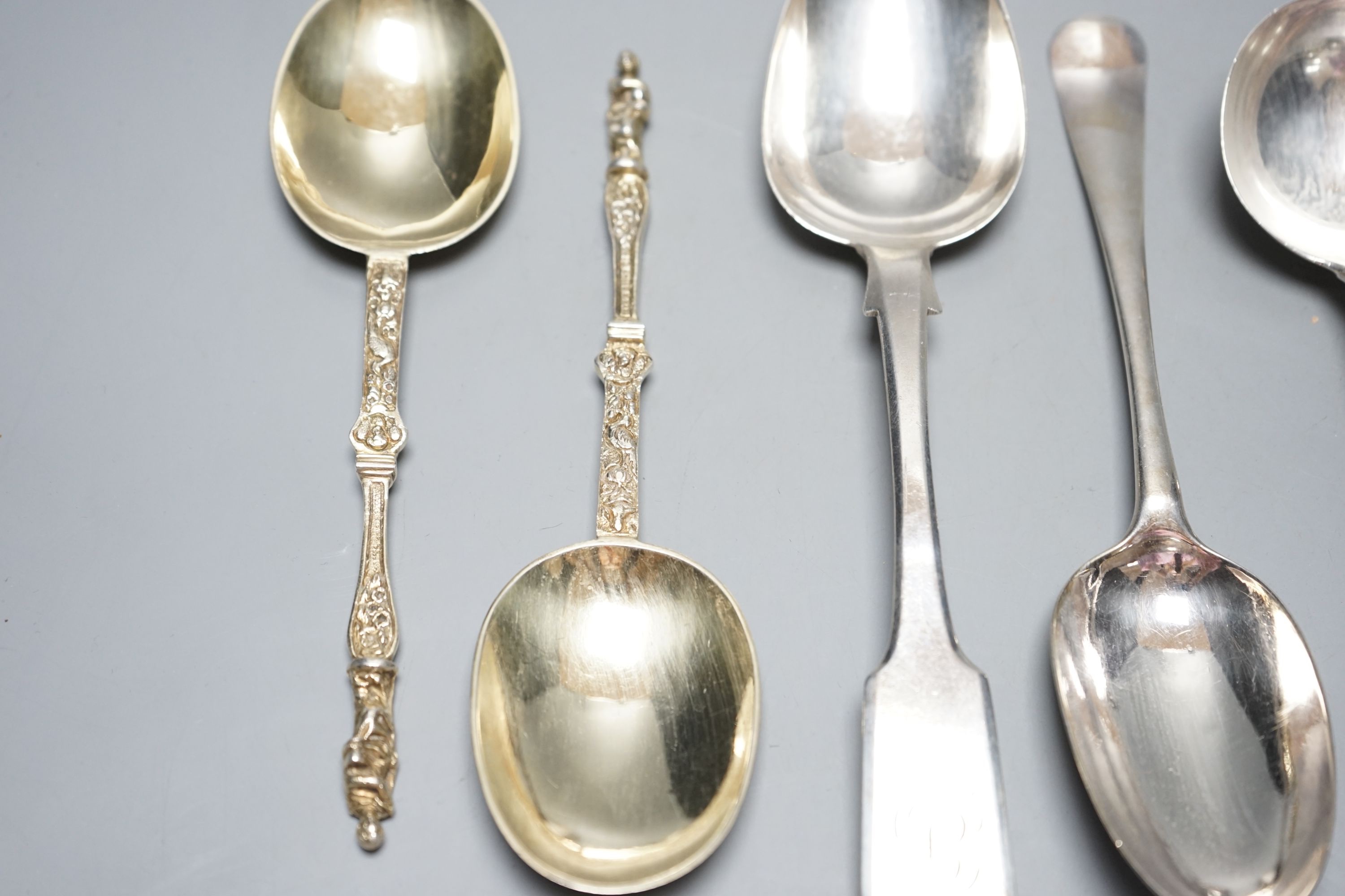 A pair of George III silver Old English pattern sauce ladles, London, 1782, 18cm, a pair of Victorian silver gilt apostle spoons, London, 1877, two Georgian silver spoons, London, 1744 & Exeter, 1818 and a sterling spoon